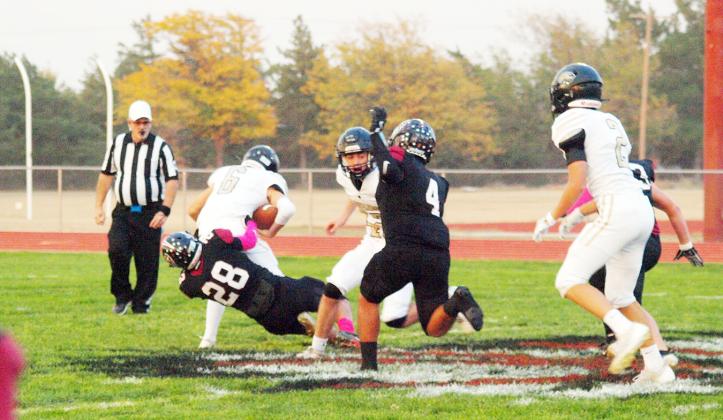 Senior Khris Hermosillo (28) pulls down the Leopards' rusher as Junior Pablo Reyes (4) prepares to engage a La Crosse player.