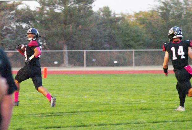 Hermosillo (28) checks behind him on the way to the end zone. Young (14) provides protection. Senior Juan Tapia (98) and other Indians defend as Young (14) makes the play.