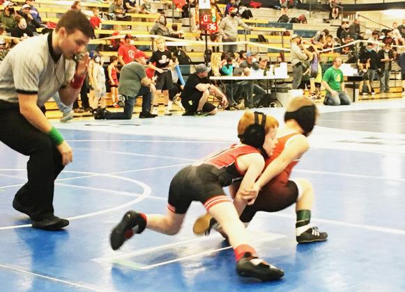 Above: Reid Marcy, 61 pounds, competes in the 6 and Under division. He placed 3rd.