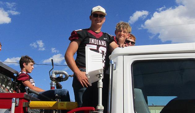 Huck Carpenter (seated), Zane Gerstberger (59), with Gannon West (13) and Whalen peeking over the cab.