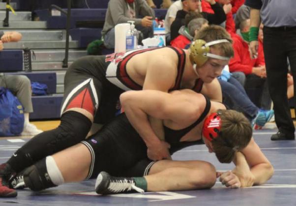 Below: Jesse Gardner presses his advantage during a match at the sub-state tournament in Minneapolis, KS, on Saturday, February 20. Photo credit Maggie Brown
