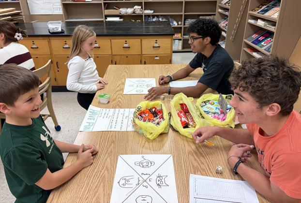 Second graders Conner Smith and Maggie Ames learn “Triple the Fun” from Santiago Garcia and Tyson Peters.