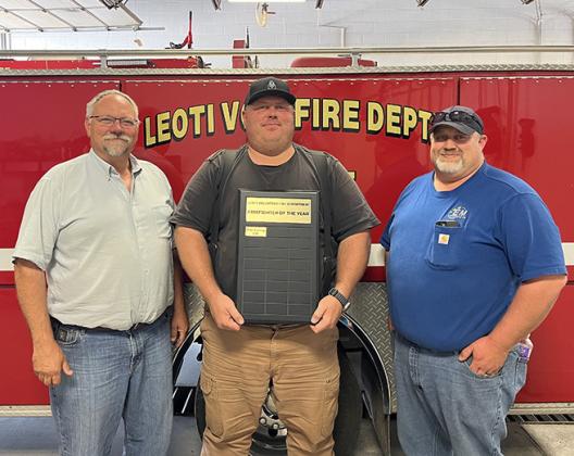 Leoti Volunteer Fire Department’s first Firefighter of the Year, Brian Downing, center, poses with Fire Chief Mike Nickelson and Asst. Fire Chief Steve Baum.