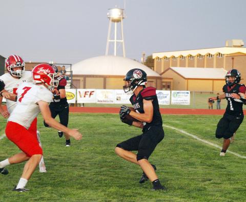 The Indians ball carrier, whom we believe to be Christian Soto-Berumen (4) confronts a wall of red and white.