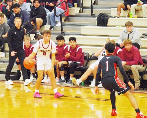 Dylan Luna, 0, determines his best way around the Mustangs defender as Coach Rietzke looks on.