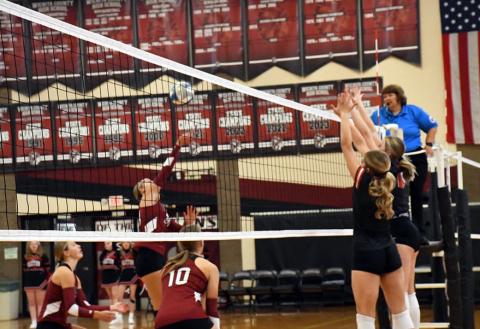 Senior attack trio for the Indians. Marcy Baker goes up for the kill while Breanne Ricke and Kenzie Porter cover. Photo by Misty Gardner