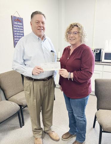 John Pinegar of the KS Legislative Policy Group is presenting the check to Diana Long, Wichita County Treasurer.