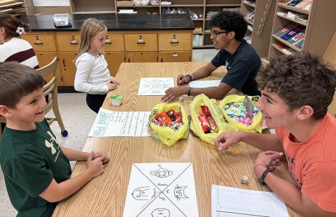 Second graders Conner Smith and Maggie Ames learn 'Triple the Fun' from Santiago Garcia and Tyson Peters.