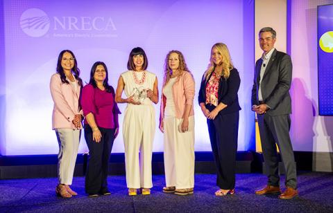 Wheatland Electric Cooperative, Inc. is presented with the Edgar F. Chesnutt Award at NRECA’s 2026 Connect Conference in San Diego, Calif. Pictured (from left) is the Member Services team: Samantha Garcia, Shajia Donecker, Alli Conine, Mary Hoisington, Caitlin Moser. Also pictured is Stephen Bell (far right), NRECA’s senior vice president of communications. (Photo: Jerry Mosemak/NRECA)