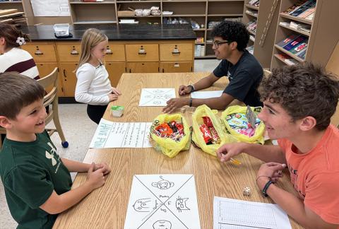 Second graders Conner Smith and Maggie Ames learn “Triple the Fun” from Santiago Garcia and Tyson Peters.