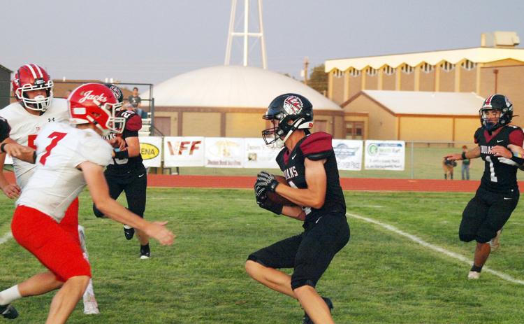 The Indians ball carrier, whom we believe to be Christian Soto-Berumen (4) confronts a wall of red and white.