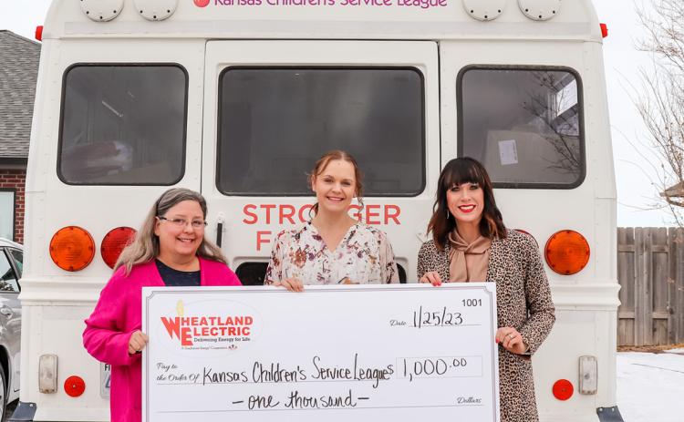 Wheatland Electric Director of Member Services and Corporate Communications, Alli Conine (right), presents a $1,000 Sharing Success grant from Wheatland Electric to the Kansas Children’s Service League.