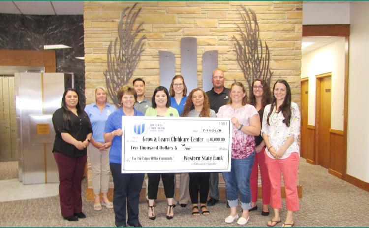 Pictured above, (l-r): Back row, Ana Sillas; Patty Medina; Doug Storie; Simone Elder, Western State Bank Assistant Vice President; Brady Harbin, Western State Bank Banking Center President; Nikki Bjurstrom, Wichita County Economic Development Director. Front row, Gertrude Estes, Western State Bank Assistant Vice President; Andrea Barreras; Marie Ruiz; Tammy Simons, Grow &amp; Learn Childcare Center Board Member; Jenny Long, Grow &amp; Learn Childcare Center Board Member. Staff Photo
