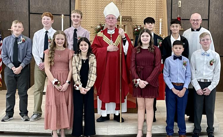 Shown above with Bishop Brungardt and Father Tim S. Hickey, pastor, are (front row from left): Charlize Shafer and Jailyn Brandl (St. Joseph the Worker, Tribune), Camryn Biermann (St. Anthony of Padua, Leoti), Marco Coello and Gavin Grilliot (St. Joseph the Worker); Gannon West (St. Anthony of Padua), Holden Whalen and Cole Carpenter (St. Mary), and Oscar Martinez and Santiago Mora Martinez (St. Joseph the Worker). (Photo courtesy Tara Biermann)