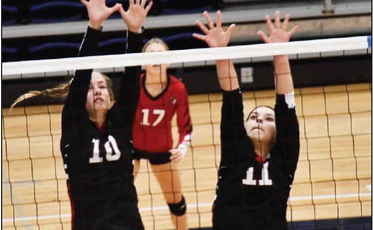 McKenzie Porter and Giselle Alcaraz go up for the block while Kaylee Wilbur covers. Photo by Misty Gardner.