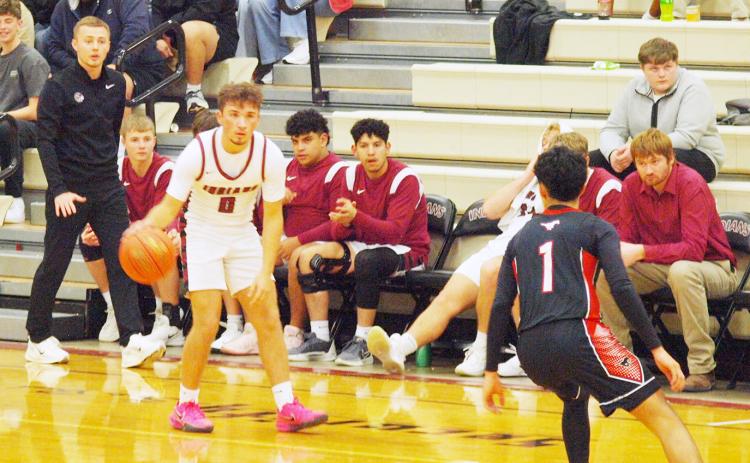 Dylan Luna, 0, determines his best way around the Mustangs defender as Coach Rietzke looks on.