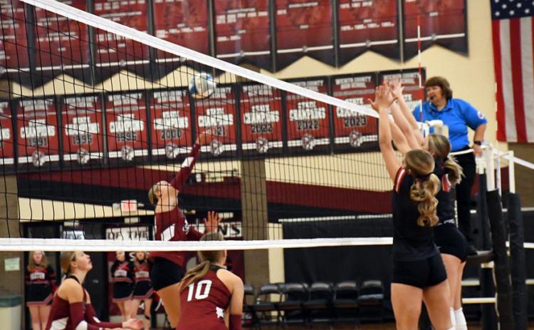 Senior attack trio for the Indians. Marcy Baker goes up for the kill while Breanne Ricke and Kenzie Porter cover. Photo by Misty Gardner