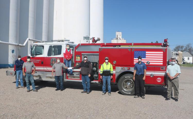 Photo cutline: Through a donation from CHS, the Greeley County Fire Department will be purchasing a thermal imaging camera to help detect hot spots in buildings. Pictured from left to right are: Greeley County Fire Department volunteers Levi Evans, Brent Tarman, Dustyn Smith, Adriana Evans and CHS representatives Jeff Kahle, Dirk Schneider, Eric Starns and Alan Peter. Photo courtesy CHS