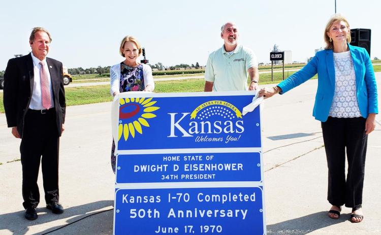 Above, from left to right, Kansas State Senator Rick Billinger (R-Goodland); Mary Eisenhower, granddaughter of President Dwight D. Eisenhower; Kansas Department of Wildlife, Parks and Tourism Secretary Brad Loveless; and Kansas Transportation Secretary Julie Lorenz participated in I-70’s 50th anniversary celebration this morning at the Kanorado weigh station. KDOT Photo