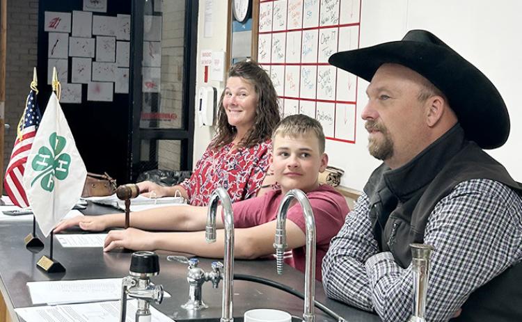 Janee Porter (mother of secretary Jentri Porter) and Heath West (father of vice president Tadyn West) help president Zane Gerstberger run the meeting. Photo courtesy Stephanie Thelan-West.