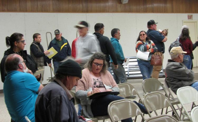 Above: Members of the community gathered at the Communit y Building on March 23, hoping to get some sweet deals on property at a u c t i o n due to delinquent, yearsold taxes.