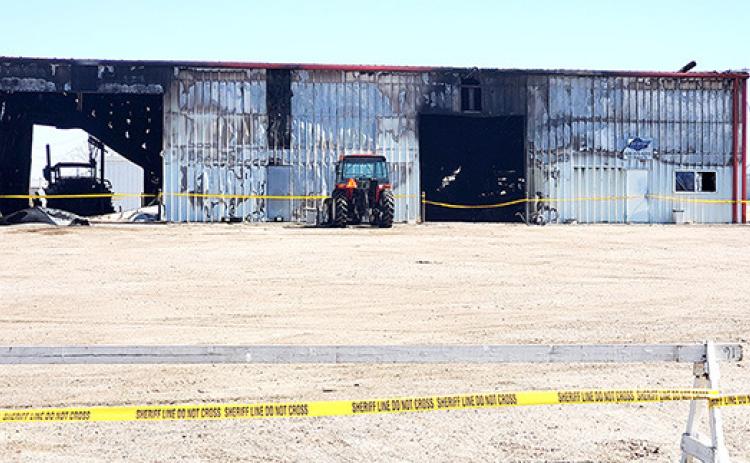 Sheriff’s Office Do Not Cross tape cordons off the Front (West side) of the Price Repair shop, which shows the scars of flames from the fire that destroyed the building on Sunday, March 17.