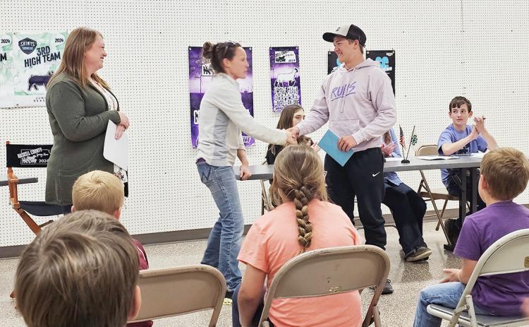 Lydia Jayhawker leaders Kyla Larson and Lora Imler congratulating their club senior, Wyatt Gardner, on his upcoming graduation.