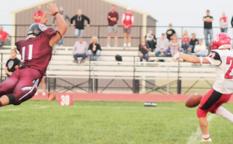 In this file photo, Senior Manny Chavez attempt to block a punt versus the Hill City Ringnecks. Credit Carson Norton