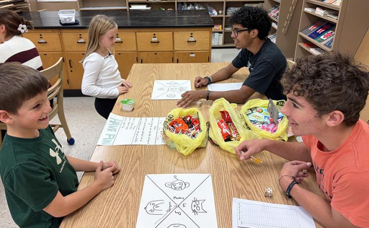 Second graders Conner Smith and Maggie Ames learn 'Triple the Fun' from Santiago Garcia and Tyson Peters.