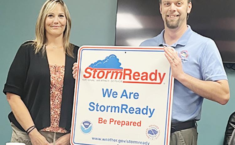 Above: Jesse Lundquist (NWS-Goodland) presents the Very Large Sign to Mindi Bremer, RN, EPM, SO. Provided