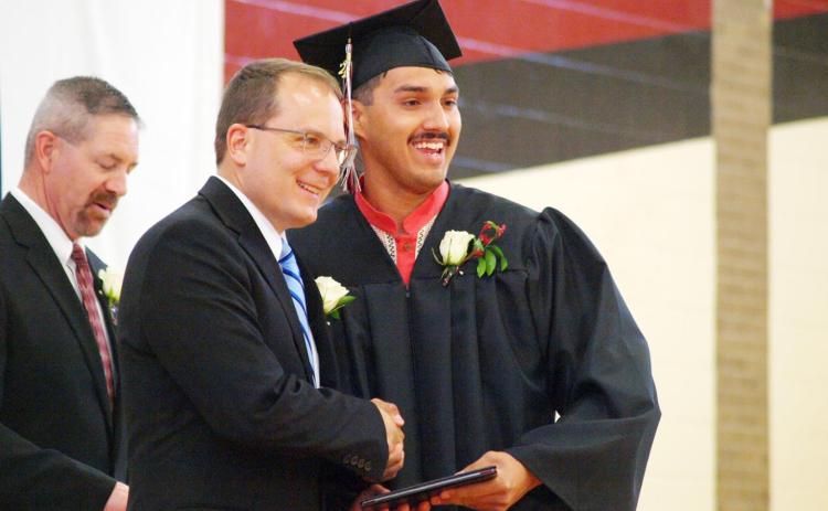 Above Left: Marco Salazar poses with Board of Education President James Myers.