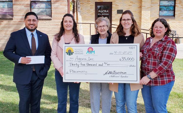 Blue Cross Blue Shield Kansas representative Miguel Rosales, Wichita County Economic Development Director Nikki Bjurstrom, and AIM Coalition’s Tammy Simons, flank Agora, Inc., board member Margaret Pritchard and board chair Simone Elder as they present Pathways to a Healthy Kansas grant funds.