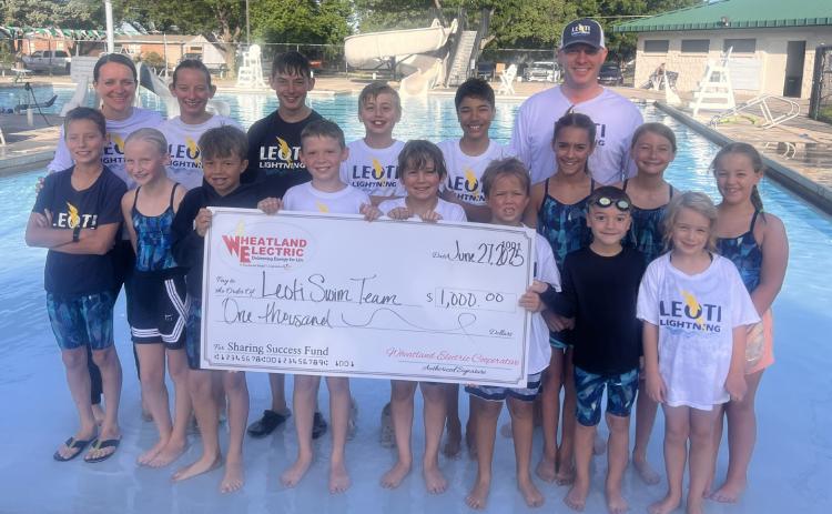 The Leoti Lightning Swim Team with coaches Jenny Long (left) and Matt Long (right) were awarded a $1,000 Wheatland Electric Sharing Success grant to help fund new starting blocks and lane line repairs.
