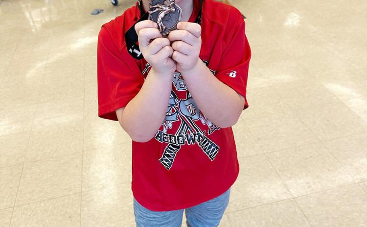 Birthday boy Brodie Wishon celebrates his 3rd place medal.