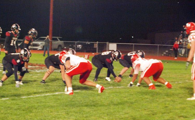 Above, the Wichita County Indians, in home black, prepare to put the ball in motion during the Sectionals playoff game at home versus the Hoxie Indians.