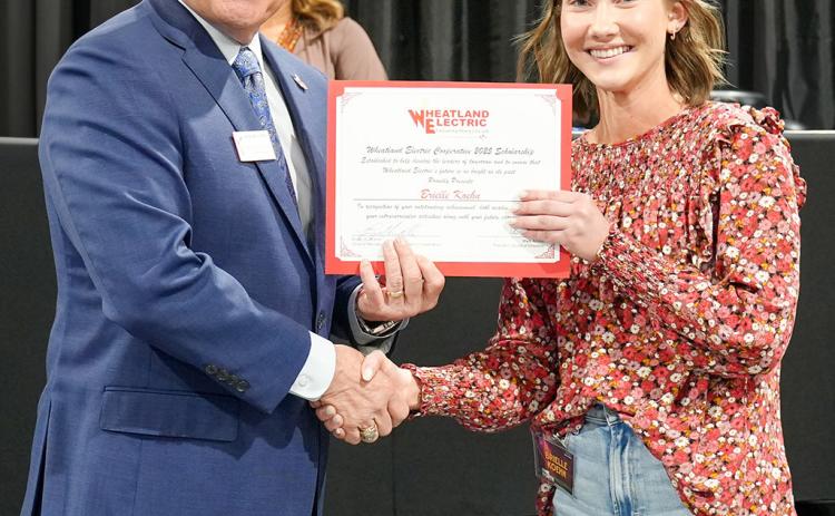 Bruce W. Mueller (left), CEO/general manager of Wheatland Electric Cooperative, Inc., awards Brielle Koehn (right), senior at Wichita County High School, with a $1,000 scholarship during WEC’s annual meeting in Scott City, Kan. on April 23.