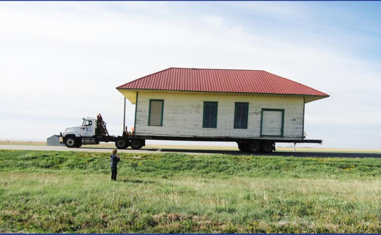 Pictured below: An ecstatic Karen Walk watches as the depot begins its serpentine journey from Selkirk to Leoti on Friday, May 1.