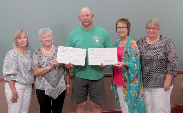 Allen Baker, Wichita County Fair board member and Wichita County Extension Agent holds the ceremonial checks for the grants the two entities received from Heart Strings to Purse Strings. Pictured with Baker are HSPS Executive Committee members (L-R): Barbie Wilbur, Dorene Reimer, Deb Bauck, and Sharla Krenzel.