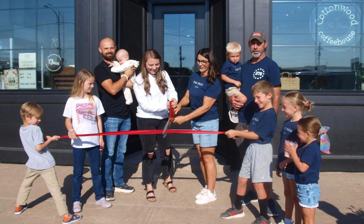 Above: Surrounded by their families, Enny Teichroeb (center left) and Aimee Burch cut the ribbon to celebrate the Grand Opening of Cottonwood Coffeehouse at The Press. Left: A view inside. Below Left: Part of the rear patio. See more photos on page 8.