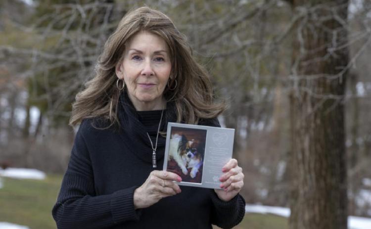 Rhonda Bomwell of Somerset holds a photograph as she talks about her 9-year-old Papillon, Pierre, who passed away on June 1st due to side effects from wearing a popular flea and tick collar for pets, at Colonial Park in Somerset, NJ Monday, March 1, 2021.