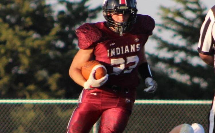 In this file photo, senior Jesse Gardner evades defenders and carries the football. Credit: Haylee Kissick