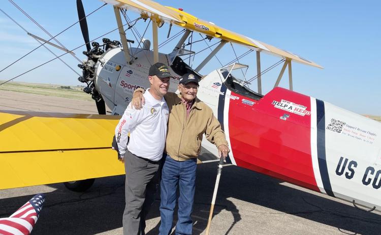 Left: Dick Sheets slings an arm around volunteer pilot John Cyrier, a Texas state representative. After the flight, Sheets gave Cyrier his World War II ballcap. Photo courtesy Becky Miller