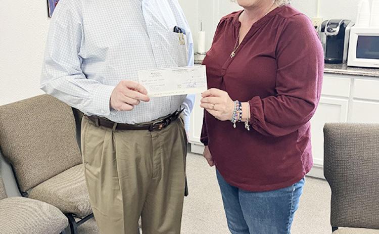John Pinegar of the KS Legislative Policy Group presents a check to Diana Long, Wichita County Treasurer. (provided)