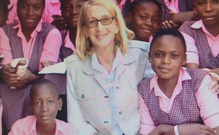 Missionary Phyllis Sortor surrounded by students. Provided