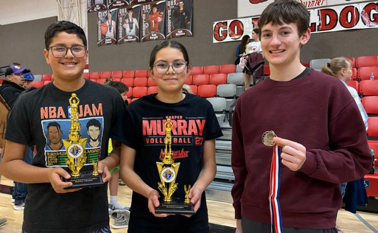 Bryan Michel, Brianna Michel, and Zachary Marcy showing the hardware they earned at the Knights of Columbus Free Throw Contest.