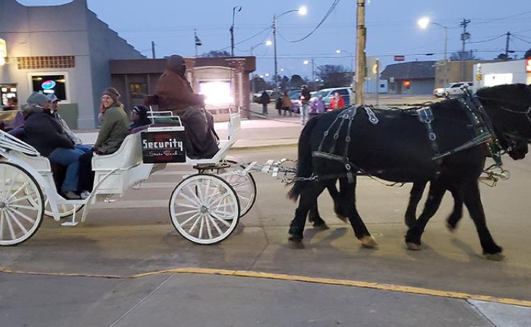 The festivities, including two different horse-drawn carriage rides, kicked off before dark.