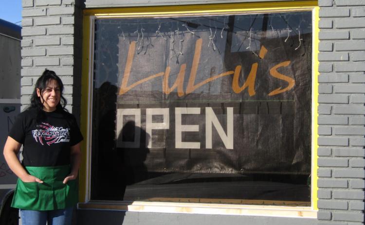 Elizabeth Ponce, one of the owners of LuLu's Mexican Eatery, poses in front of her new restaurant, which occupies the former Sewing Box building. Staff Photo