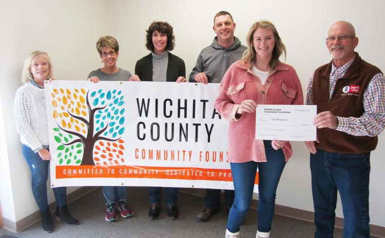 Wichita County Community Foundation Board Members (L-R) Barbie Wilbur, Carlotta Brack, Deb Smith, and Matt Long gather to congratulate contest winner Jen McKinney, who won both the logo and tagline portions of the competition. McKinney (in pink) is seen here accepting a check from board chair Bruce Leisy. Staff Photo