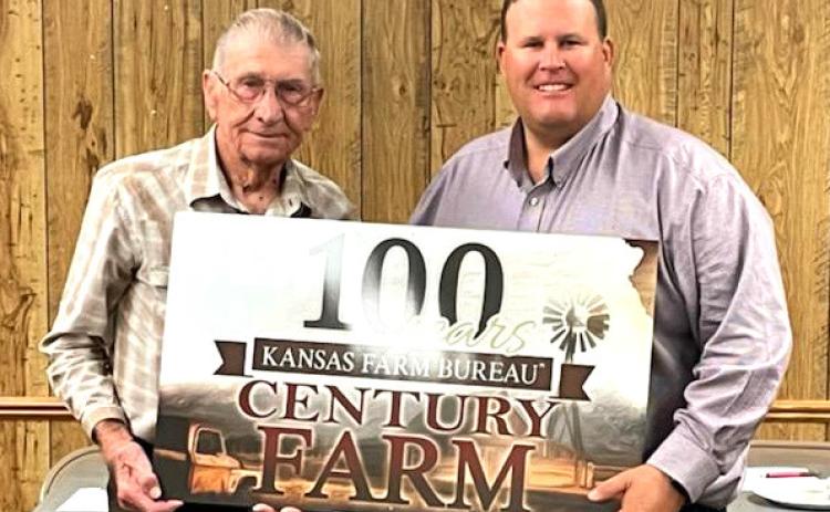 Left: Gus Luebbers receives a sign from Wichita County Farm Bureau President Russ Lewis. Photo courtesy Farm Bureau