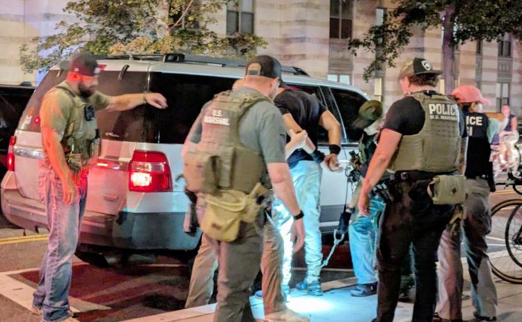 U.S. Marshals and Homeland Security Investigations agents take a man into custody on Sept. 3, 2025, at the intersection of 14th and N streets NW in Washington, D.C. (Ashley Murray/States Newsroom)
